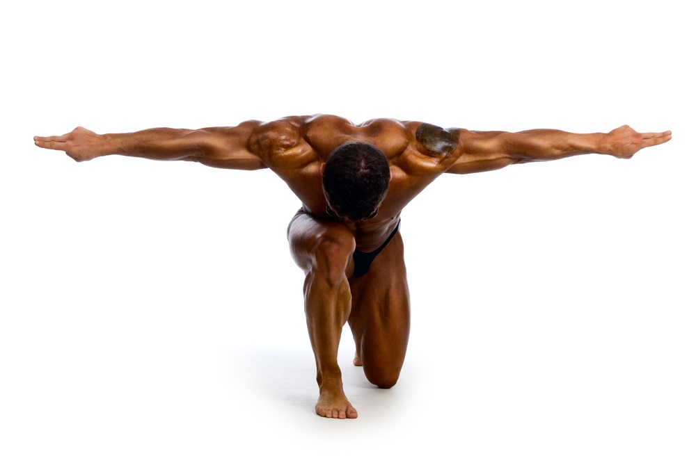 Bodybuilder with arms outstretched side by side of head