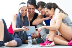 Group of fitness people looking at a tablet