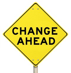 A yellow diamond-shaped road sign cautions with "Change Ahead."