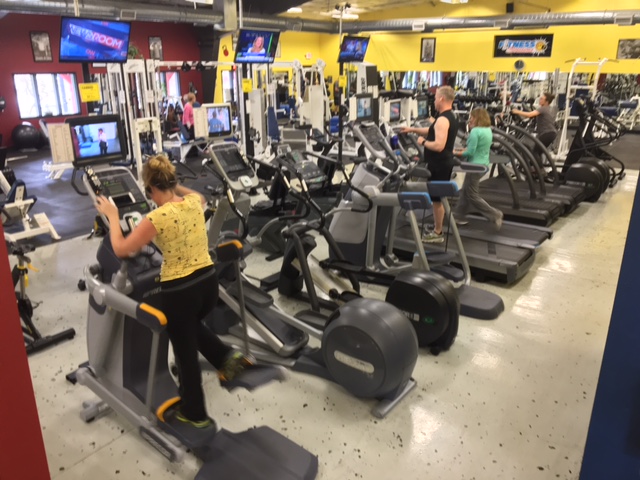 Customers using equipment purchased through gym maintenance fees.