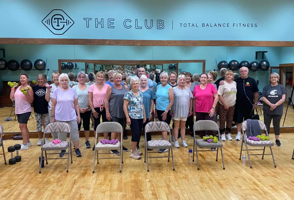 Seniors showing off an exercise fitness trend of chair-based challenges.