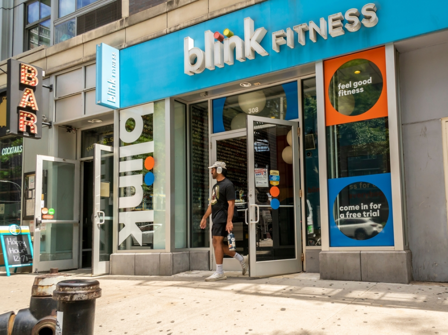 Man walks out of a successful gym owner's  business. 