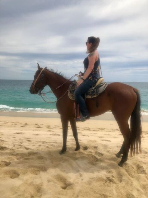 Software customer support employee Jaz riding horses in Cabo Bello, Mexico.